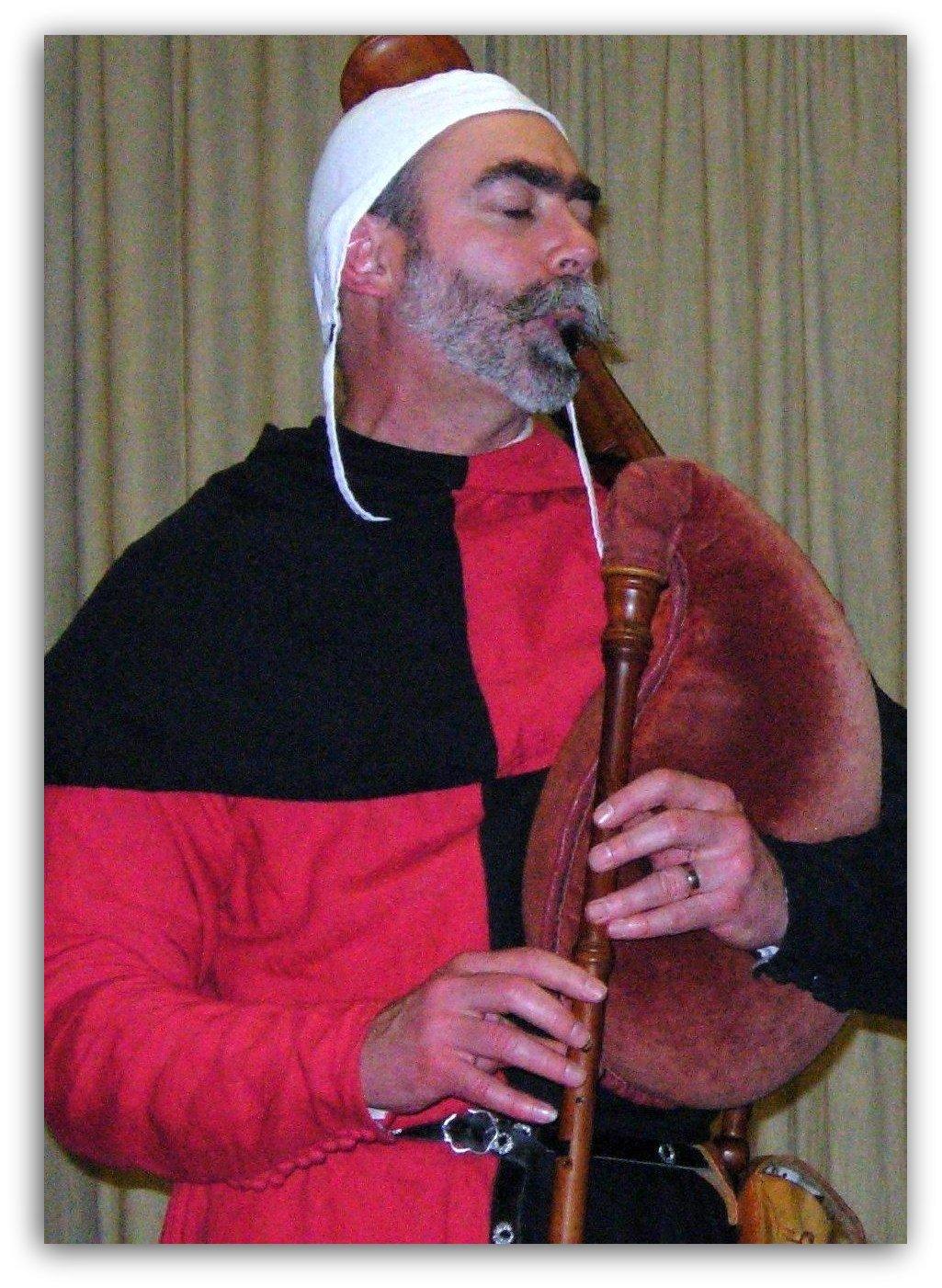 medieval musician entertains guests at banquet